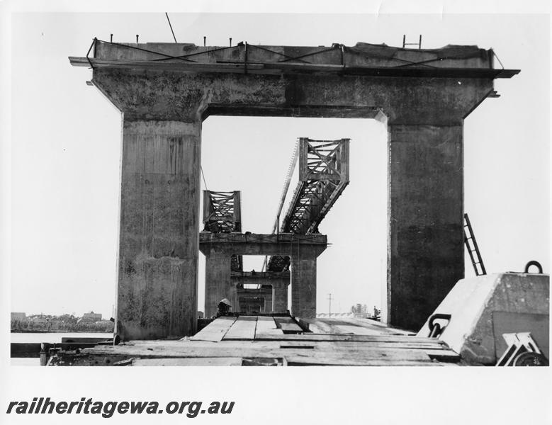 P00105
68 of 98 images showing views and aspects of the construction of the steel girder bridge with concrete pylons across the Swan River at North Fremantle.
