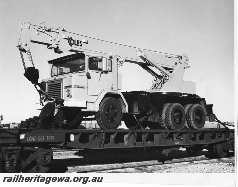 P00270
Mobile truck mounted crane being secured to a non Westrail bogie flat wagon, end and side view.
