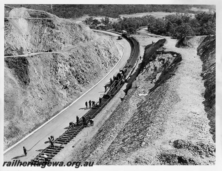 P00375
Standard gauge construction, tracklaying in Windmill Cutting, rail train being unloaded, elevated view
