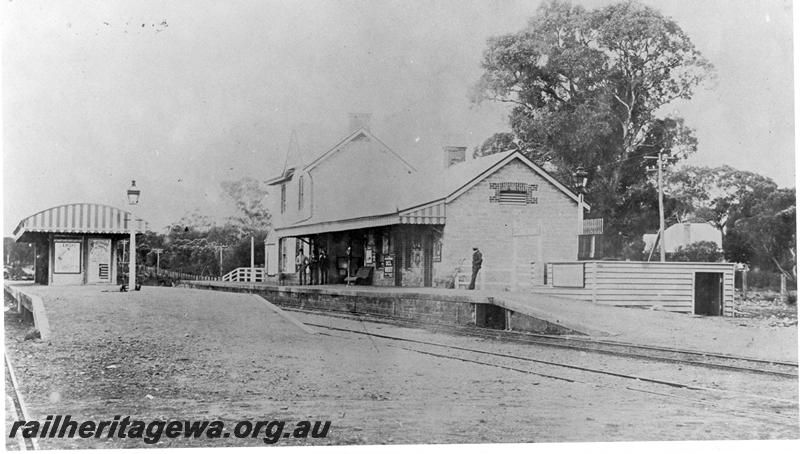 P00387
Station buildings, Claremont, early view of main building and island platform building before the construction of the elevated signal box, view along track looking east towards Perth.
