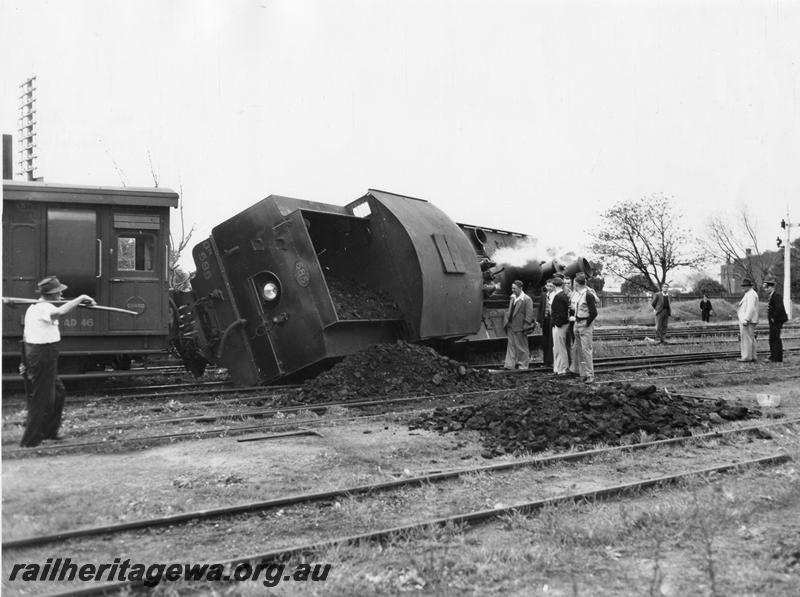 P00445
3 of 4 views of DM class 585 on No. 195 Passenger derailed and lying on its side, Midland Junction, end and side view, guards compartment of AD class 46 in view, date of derailment 30/7/1953
