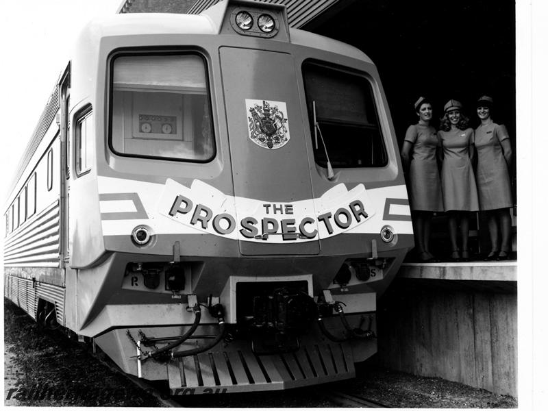 P00895
Prospector railcar, orange and white front livery, three hostesses on platform, front view of car, Royal Train for Prince Charles, see also P7881-P7884, (Ref: 