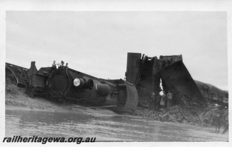 P01017
F class on No. 105 Mixed Goods derailed and lying on its side, derailed wagons piled up behind, Dumberning, BN line front and side view. Date of derailment 14/3/1934
