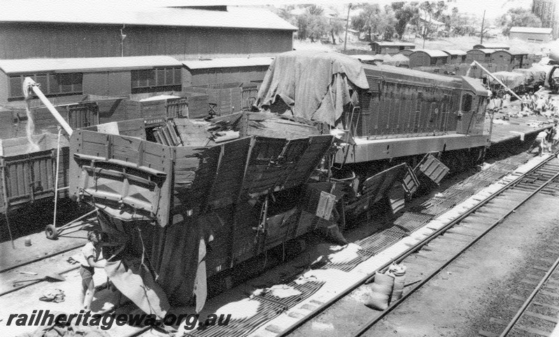 P01023
1 of 10 views of the derailment of A class 1501 on No.97 Goods at Northam Station, ER line on 2nd November, 1961. View shows loco on top of wagons
