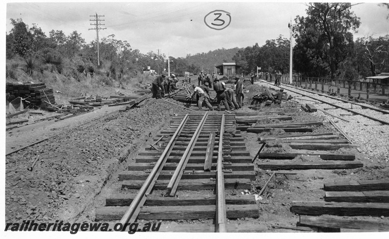 P01053
Track, installing the double slip in the Parkerville yard, ER line, view of workers skidding the double slip into position.
