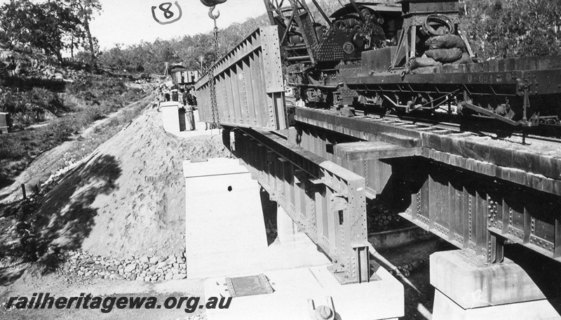 P01435
10 of 13 images of the construction of the duplicate steel girder bridge No.1 at 16 miles 25 chains on the ER through the John Forrest National Park, main girder being placed into position on pylons.

