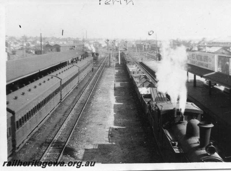 P01671
Perth Station, ER line, looking west, train of AT class carriages at platform No. 1, N class loco hauling a goods train, goods yards and sheds marked 1 and carriage shed marked 0 on photo.
