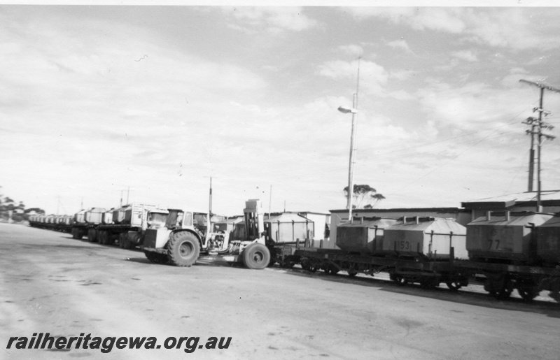 P01854
Front end loader loading nickel containers onto flat wagons, Widgiemooltha, CE line
