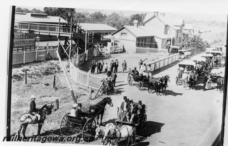 P01871
Horse drawn vehicles, station buildings, Claremont, on the occasion of Sir John Forrest arriving at the station, streetside view looking east.
