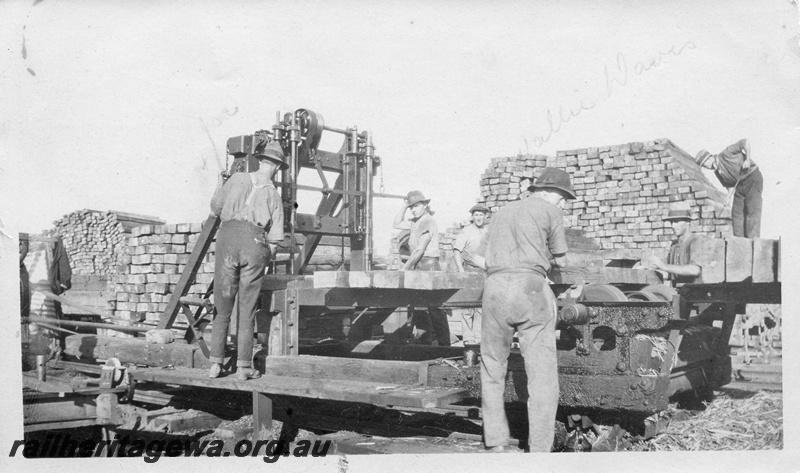 P01961
Track construction, Merredin, EGR line, workers drilling holes in sleepers using a vertical drilling press.
