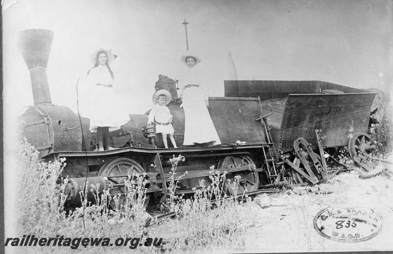 P01971
Loco Ballaarat with steel tender,derelict, Busselton, a young boy and two females all well dressed posing on the footplate,  front and side view,  see P07649 for a better image
