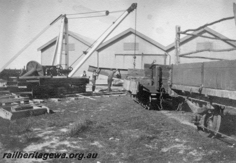 P02090
11 of 44 views of the construction of the railway at Esperance, CE line taken by Cedric Stewart, the resident WAGR engineer, derrick cane lifting steel girders from H class wagons in front of the goods shed.

