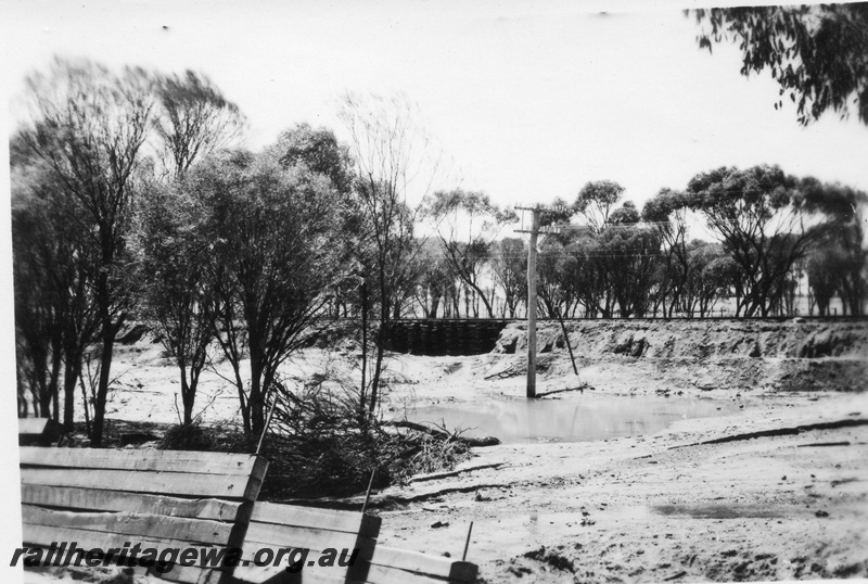 P02131
7 of 7 views of flooding and washaways on the Narrogin to Wagin section of the GSR, section of washed away track supported on a large 