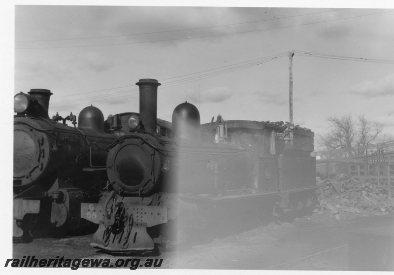 P02176
G class 55, Bunbury Loco depot, SWR line, front and side view, wood fuel in tender.
