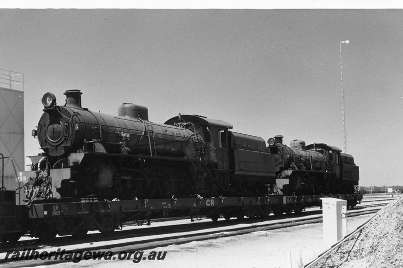 P02402
W class 933 and W class 934 steam locomotive loaded on Commonwealth Railways (CR) flat top wagons on route to Pt Augusta, front and side view.
