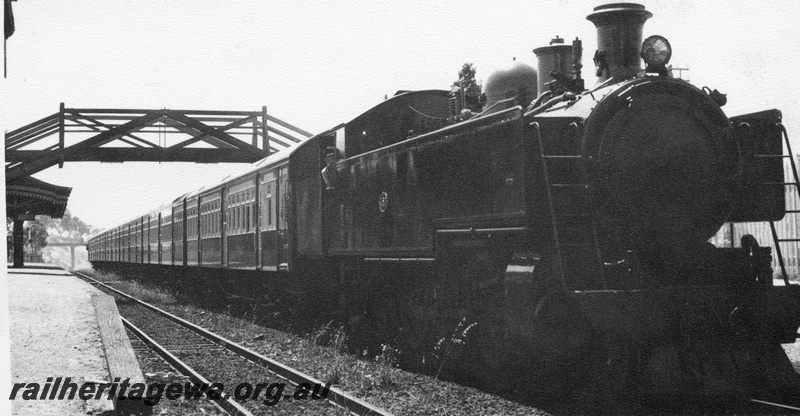 P02480
DM class 4-6-4- t loco with rake of new AY class carriages in the cream and green livery, footbridge, possibly at Maylands.
