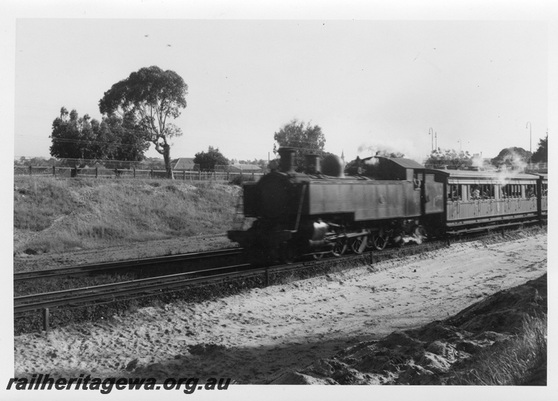 P02517
DD class steam locomotive on suburban passenger working, front and side view.
