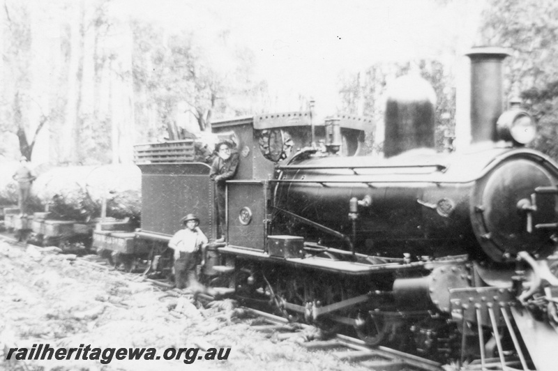 P02951
State Saw Mills (SSM) G class 57 steam locomotive, logging train hauling a rake of loaded jinkers, driver and fireman posing for the photograph, side and front view, Pemberton.
