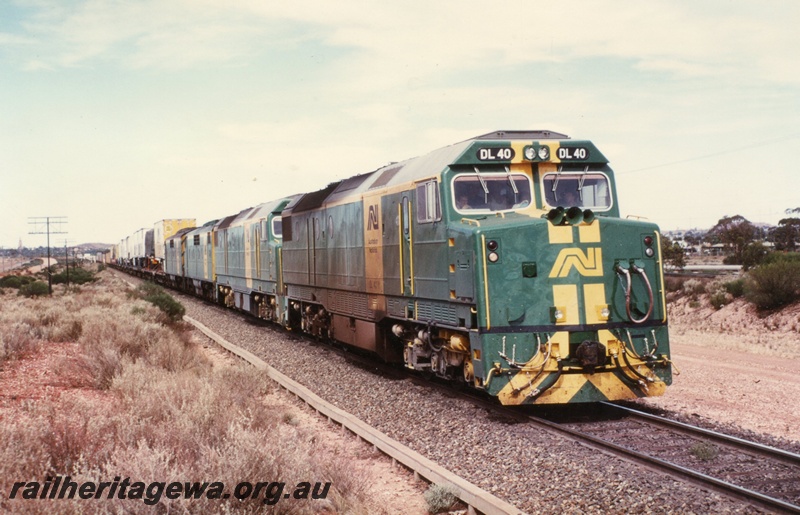 P03338
DL class 40 and 45, GM class 22 and 46 diesel locomotives on a freight train approaching West Kalgoorlie, two man crew on leading loco.
