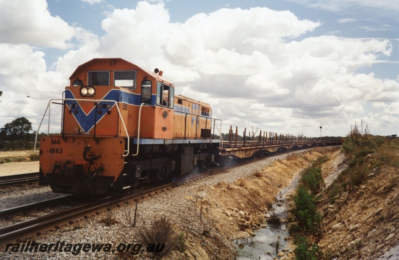 P03349
MA class 1863 diesel locomotive in the Westrail orange livery hauling a rake of QU class bogie flat wagons loaded with welded rail from the Midland Depot to Forrestfield.
