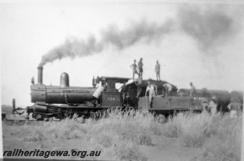 P03383
G class 234, being coaled from an open wagon, PM line, side view.

