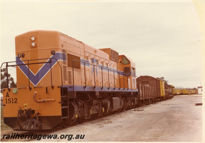 P03873
3 of 3, A class 1512 diesel locomotive on mixed goods train, front and side view, Westrail orange livery, on route to Geraldton.
