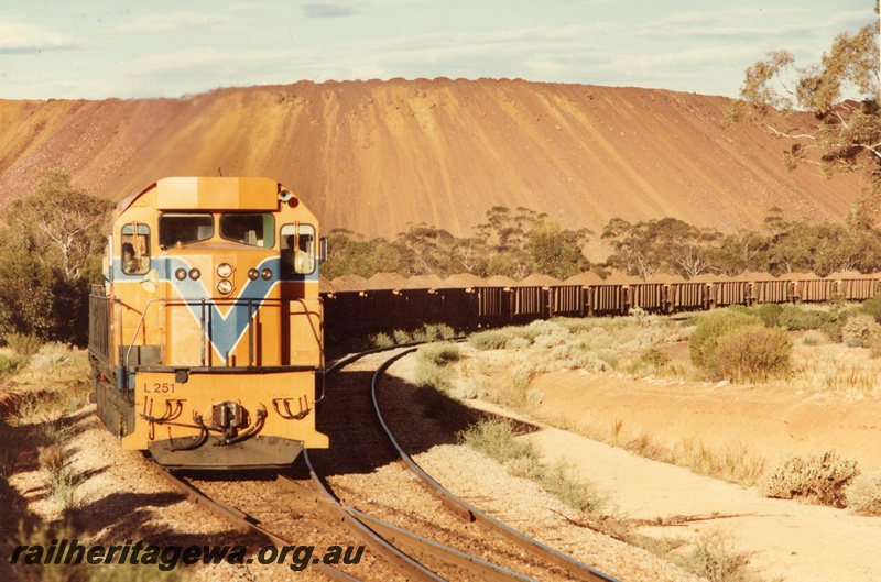 P03925
L class 251 standard gauge diesel locomotive, front view, in Westrail orange livery, on iron ore train, WO class iron ore wagons, on route to Kwinana, standard gauge line. 
