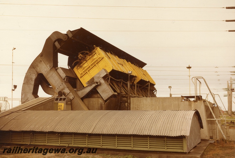 P03929
1 of 2, GH class high-sided coal wagons, in yellow livery, being unloaded, Bunbury, SWR line.
