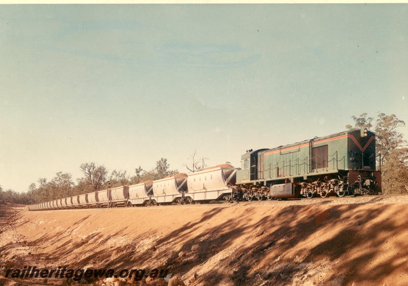 P03935
2 of 2, R class 1904 diesel locomotive in the green with red and yellow stripe livery, hauling a bauxite train, three XBC class hoppers then XC class hoppers, side and front view
