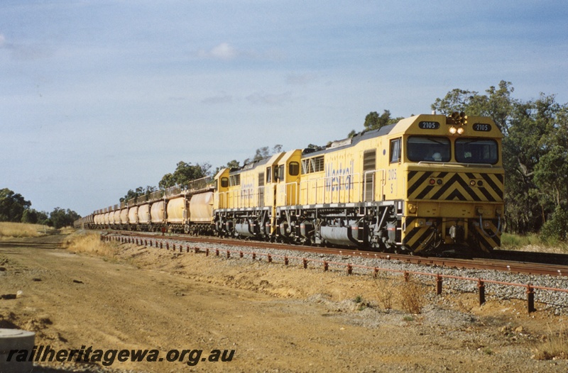 P04299
S class 2105 double heading with S class 2102 diesel locomotives in Westrail yellow with black chevrons livery, side and front view, on combined lime and coal train.
