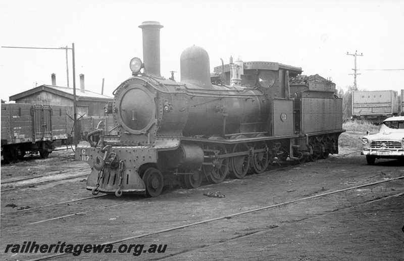 P04358
G class 117 steam locomotive, with pressed steel cowcatcher, electric headlight and cab side curtains front and side view, GE class 11720 in background, 