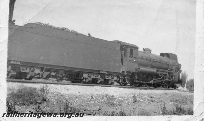 P04375
Commonwealth Railways (CR) C class steam locomotive, side view of tender and loco, on the Nullarbor.
