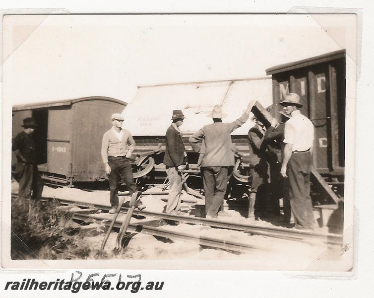 P05517
Derailment 144.25 mile, near Marchagee, MR line, workmen around derailed MRWA LC class bogie van and other wagons,  date of derailment 20/6/1936
