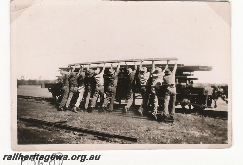 P05688
WA Goldfields Firewood Co. rail recovering train. at Calooli, workers loading rails onto a wagon

