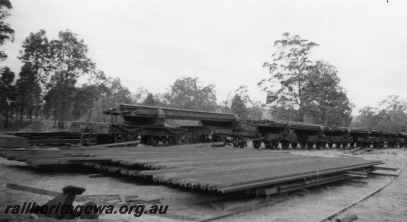 P06532
Timber jinkers loaded with rail, stack of rail in foreground, near Mundijong
