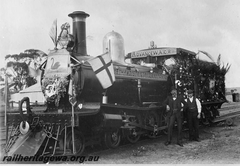 P06904
G class loco with railway personnel posed in front of cab, front and side view, Loco decorated for the 