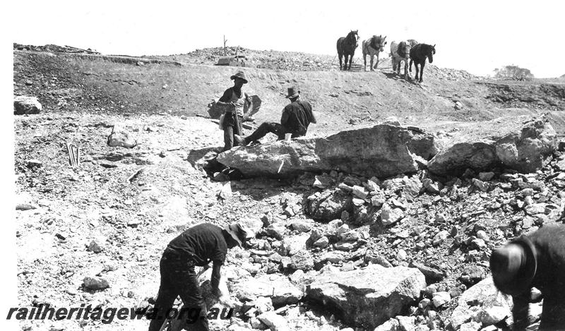 P07297
12 of 19 photos of the construction of the railway dam at Wurarga. NR line, rock after firing with explosives, horse team in background.
