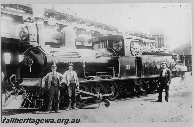P07564
G class 32, 2-6-0 steam locomotive, in original condition,front and side view, elevated coal stage, water tower and shed in the background, workers standing in front of the loco, Kalgoorlie, EGR line, c1893-94. Same as  P02822 & P07414
