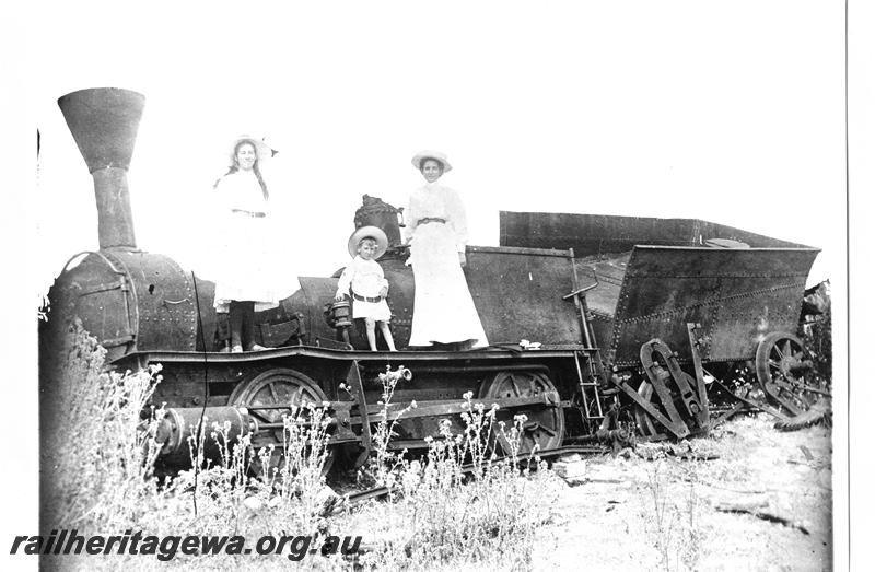 P07649
Loco Ballaarat with steel tender,derelict, Busselton, a young boy and two females all well dressed posing on the footplate,  front and side view,  same as P01971
