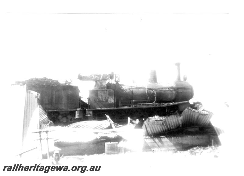 P07720
6 of 8 views of the burnt down running shed at Port Hedland, PM line on 9.10.1950, the night before the annual visit by the Chief Boiler inspector (Jack Farr), accompanied by a fitter (Ted Bosworth) and a boiler maker. G class 234 was badly damaged in the fire, side view of G class 234
