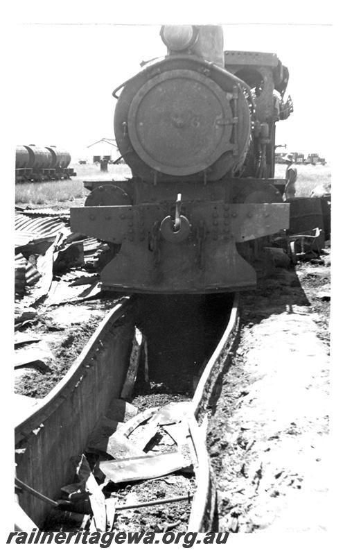 P07722
8 of 8 views of the burnt down running shed at Port Hedland, PM line on 9.10.1950, the night before the annual visit by the Chief Boiler inspector (Jack Farr), accompanied by a fitter (Ted Bosworth) and a boiler maker. G class 234 was badly damaged in the fire, View of front of g class 234 showing buckled rails on pit
