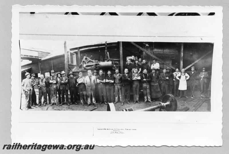 P08057
Group photo of Millars workers at the Yarloop workshops standing in front of a rail mounted log hauler.
