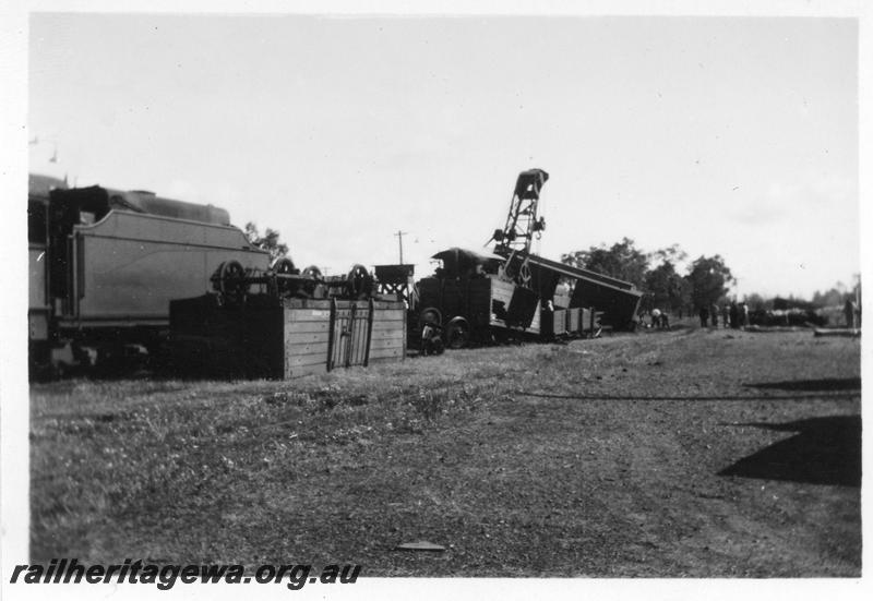 P08134
3 of 7 views of the collision at Yarloop, SWR line, by a train headed by W class 951 and a stationary goods train. The 25 ton breakdown crane lifting Z class 65 brakevan, U class tender in view.
