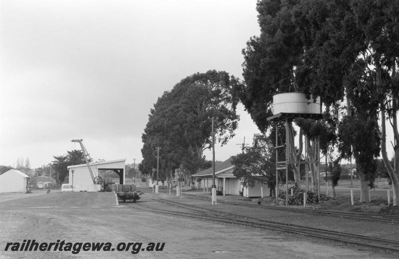 P08793
Water tower, goods shed, station building, Kojonup, DK line, view of yard looking east.
