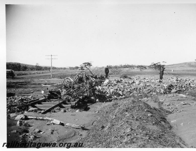 P08869
5 of 15 views of the aftermath of the washaway at Coondle, CM line on the 3rd of March 1934, debris piled up on the track

