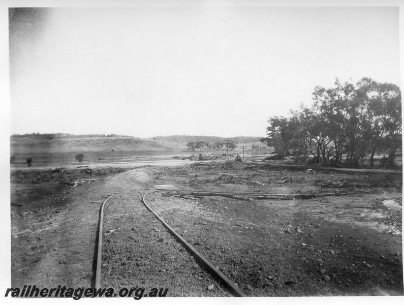 P08873
9 of 15 views of the aftermath of the washaway at Coondle, CM line on the 3rd of March 1934, view along track showing the rails displace at right angles to the trackbed.
