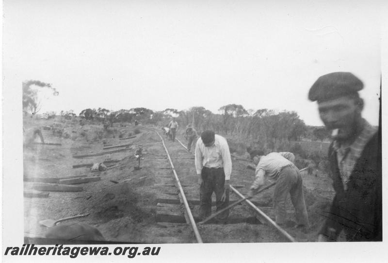 P08909
25 of 29 views of the construction of the Wyalkatchem-Lake Brown-Southern Cross railway, WLB line. Gangers levelling and straightening newly laid track

