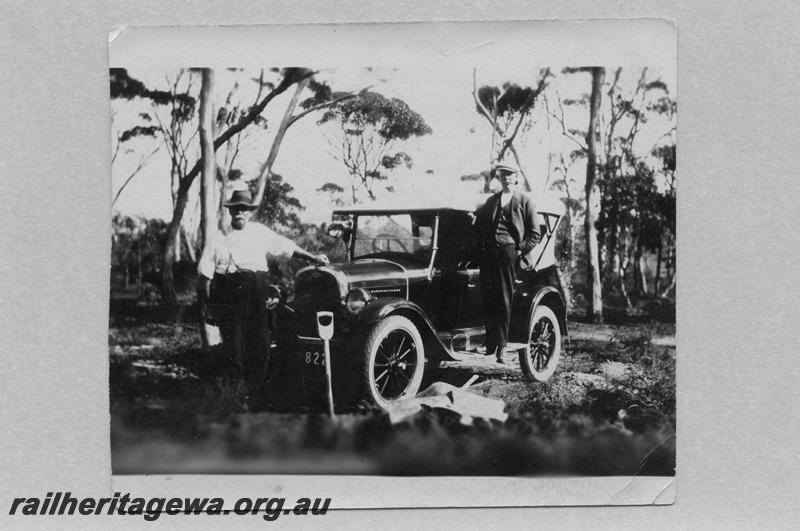 P08910
26 of 29 views of the construction of the Wyalkatchem-Lake Brown-Southern Cross railway, WLB line. Two men posing in front of a possibly bogged motor vehicle. 
