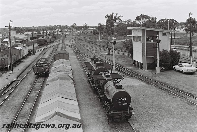 P09070
JOA class 40428 and other wagons, signal box, yard, Narrogin, GSR line elevated view taken from the footbridge over the yard looking north
