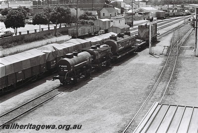 P09073
JOA class 40428 and other wagons being shunted by a Y class, yard, Narrogin, GSR line elevated view taken from the footbridge over the yard looking north
